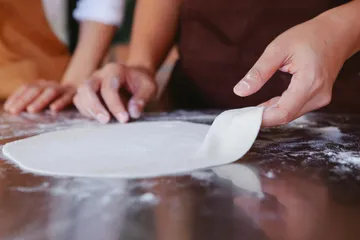 How to Stretch Pizza Dough Without Tearing It